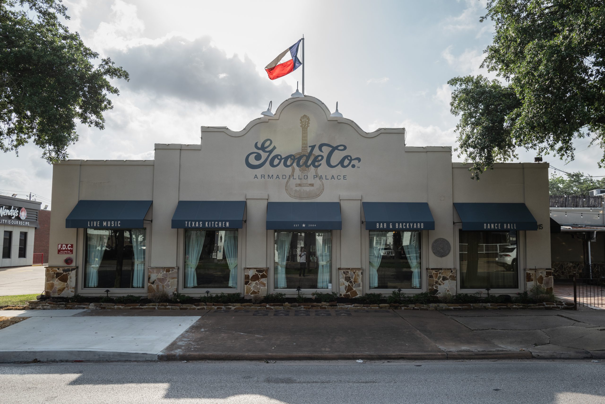 Exterior view of the The Armadillo Palace with Texas Flag on Top of the Building